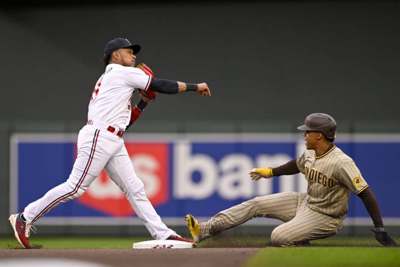 May 9, 2023; Minneapolis, Minnesota, USA;  Minnesota Twins infielder Jorge Polanco (11) throws over San Diego Padres outfielder Juan Soto (22) to complete a double play during the second inning at Target Field. Mandatory Credit: Nick Wosika-USA TODAY Sports