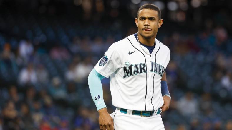 May 9, 2023; Seattle, Washington, USA; Seattle Mariners center fielder Julio Rodriguez (44) waits for his glove and hat from a teammate after striking out to end the seventh inning against the Texas Rangers at T-Mobile Park. Mandatory Credit: Joe Nicholson-USA TODAY Sports