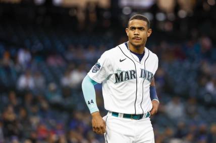 May 9, 2023; Seattle, Washington, USA; Seattle Mariners center fielder Julio Rodriguez (44) waits for his glove and hat from a teammate after striking out to end the seventh inning against the Texas Rangers at T-Mobile Park. Mandatory Credit: Joe Nicholson-USA TODAY Sports