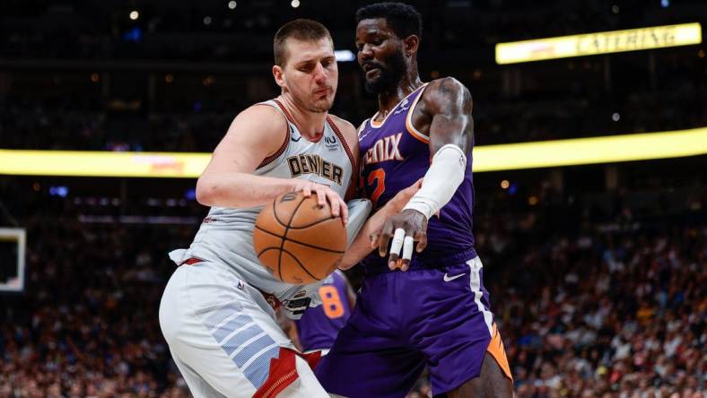 May 9, 2023; Denver, Colorado, USA; Denver Nuggets center Nikola Jokic (15) controls the ball as Phoenix Suns center Deandre Ayton (22) defends in the fourth quarter during game five of the 2023 NBA playoffs at Ball Arena. Mandatory Credit: Isaiah J. Downing-USA TODAY Sports