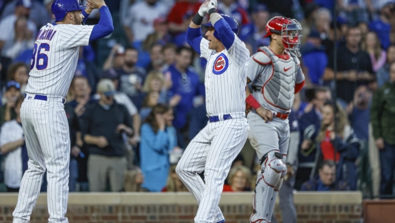 May 10, 2023; Chicago, Illinois, USA; Chicago Cubs catcher Yan Gomes (15) celebrates with first baseman Trey Mancini (36) after hitting a two-run home run against the St. Louis Cardinals during the fourth inning at Wrigley Field. Mandatory Credit: Kamil Krzaczynski-USA TODAY Sports
