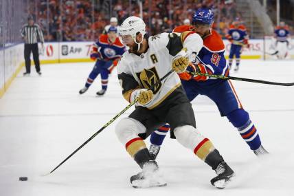 May 10, 2023; Edmonton, Alberta, CAN; Vegas Golden Knights defensemen Alex Pietrangelo (7) looks to move the puck in front of Edmonton Oilers forward Evander Kane (91) during the third period in game four of the second round of the 2023 Stanley Cup Playoffs at Rogers Place. Mandatory Credit: Perry Nelson-USA TODAY Sports