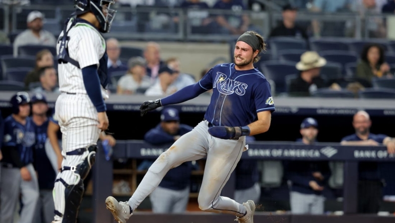 May 11, 2023; Bronx, New York, USA; Tampa Bay Rays right fielder Josh Lowe (15) scores a run against New York Yankees catcher Jose Trevino (39) on a double by first baseman Yandy Diaz (not pictured) during the fifth inning at Yankee Stadium. Mandatory Credit: Brad Penner-USA TODAY Sports