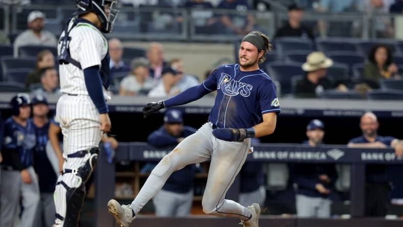 May 11, 2023; Bronx, New York, USA; Tampa Bay Rays right fielder Josh Lowe (15) scores a run against New York Yankees catcher Jose Trevino (39) on a double by first baseman Yandy Diaz (not pictured) during the fifth inning at Yankee Stadium. Mandatory Credit: Brad Penner-USA TODAY Sports