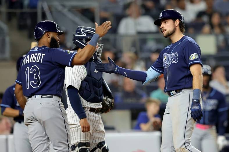 May 11, 2023; Bronx, New York, USA; Tampa Bay Rays right fielder Josh Lowe (15) celebrates his two run home run against the New York Yankees with center fielder Manuel Margot (13) during the eighth inning at Yankee Stadium. Mandatory Credit: Brad Penner-USA TODAY Sports