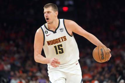 May 11, 2023; Phoenix, Arizona, USA; Denver Nuggets center Nikola Jokic (15) dribbles against the Phoenix Suns during the second half of game six of the 2023 NBA playoffs at Footprint Center. Mandatory Credit: Joe Camporeale-USA TODAY Sports