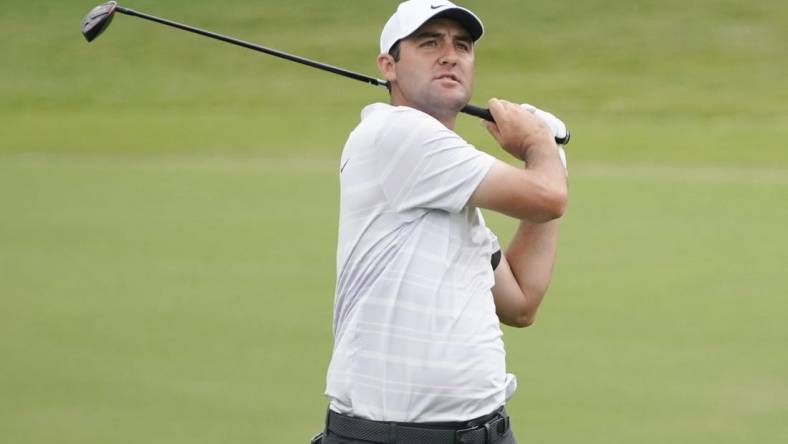 May 12, 2023; McKinney, Texas, USA; Scottie Scheffler watches shot on the 18th hole during the second round of the AT&T Byron Nelson golf tournament. Mandatory Credit: Raymond Carlin III-USA TODAY Sports