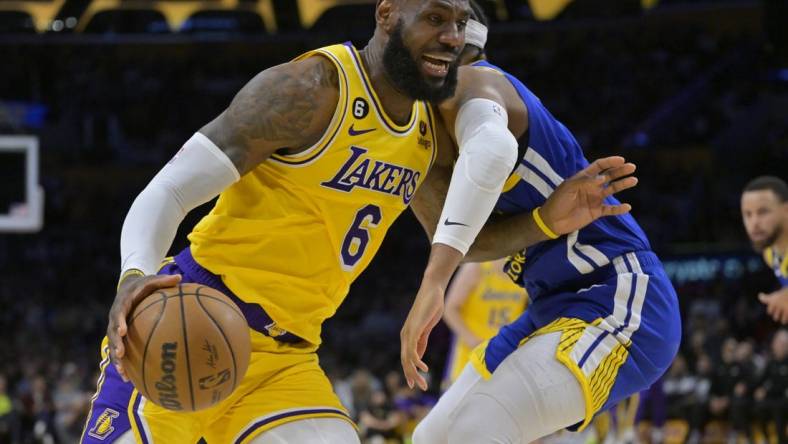 May 12, 2023; Los Angeles, California, USA; Los Angeles Lakers forward LeBron James (6) is defended by Golden State Warriors guard Moses Moody (4) as he drives to the basket in the first half of game six of the 2023 NBA playoffs at Crypto.com Arena. Mandatory Credit: Jayne Kamin-Oncea-USA TODAY Sports