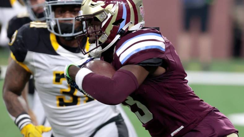 Michigan Panthers wide receiver Ishmael Hyman runs for extra yards as Pittsburgh Maulers defender Kyahva Tezino closes in to stop him during the game at Ford Field in Detroit on Saturday, May 13, 2023. The Maulers beat the Panthers, 23-7.