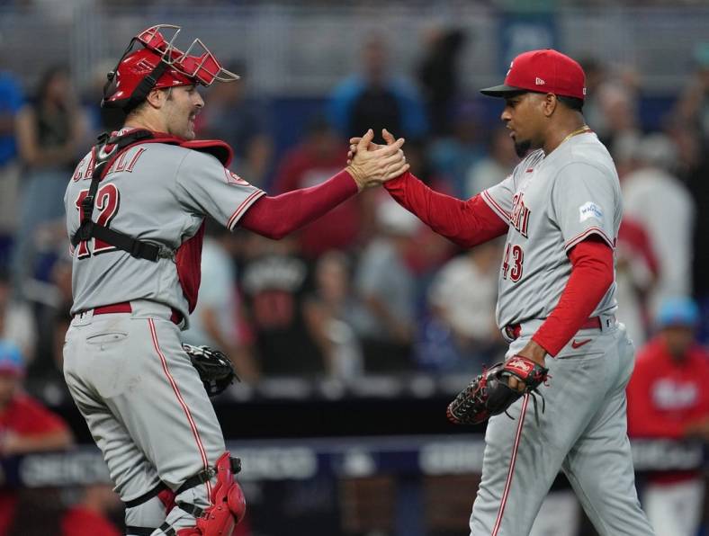 May 13, 2023; Miami, Florida, USA; Cincinnati Reds relief pitcher Alexis Diaz (43) and catcher Curt Casali (12) celebrate a victory over the Miami Marlins at loanDepot Park. Mandatory Credit: Jim Rassol-USA TODAY Sports