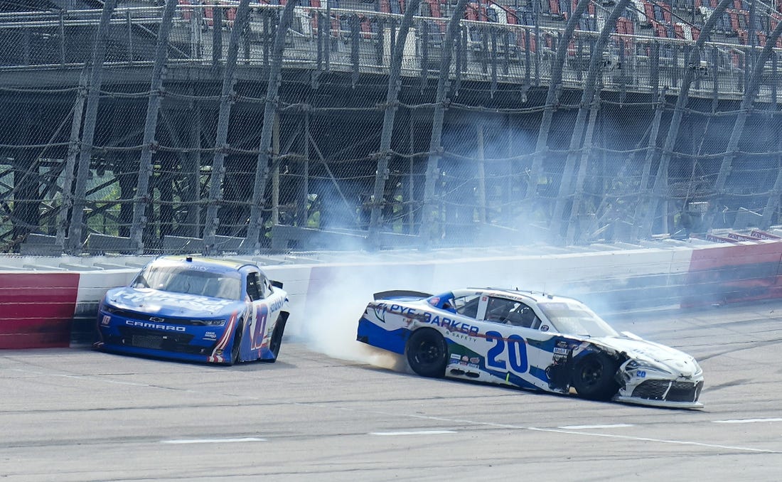 May 13, 2023; Darlington, South Carolina, USA; NASCAR Xfinity Series driver John Hunter Nemechek (20) wrecks as  Kyle Larson (10) drives to the checkered flag during the Xfinity Series Shriners Children   s 200 at Darlington Raceway. Mandatory Credit: David Yeazell-USA TODAY Sports