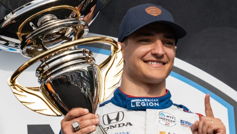 Chip Ganassi Racing driver Alex Palou (10) holds the first place first place trophy Saturday, May 13, 2023, after the GMR Grand Prix at Indianapolis Motor Speedway.