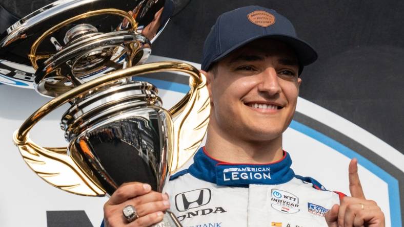 Chip Ganassi Racing driver Alex Palou (10) holds the first place first place trophy Saturday, May 13, 2023, after the GMR Grand Prix at Indianapolis Motor Speedway.