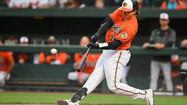 May 13, 2023; Baltimore, Maryland, USA; Baltimore Orioles catcher Adley Rutschman (35) hits a home run in the first inning against the Pittsburgh Pirates at Oriole Park at Camden Yards. Mandatory Credit: Reggie Hildred-USA TODAY Sports