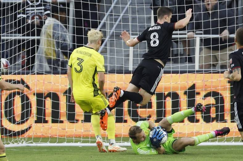 May 13, 2023; Washington, District of Columbia, USA; Nashville SC goalkeeper Joe Willis (1) makes a save in front of D.C. United midfielder Chris Durkin (8) and Nashville SC defender Lukas MacNaughton (3) in the first half at Audi Field. Mandatory Credit: Geoff Burke-USA TODAY Sports