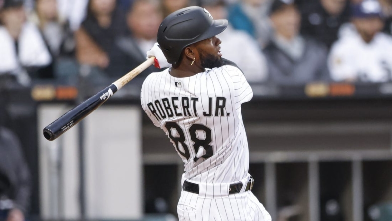 May 13, 2023; Chicago, Illinois, USA; Chicago White Sox center fielder Luis Robert Jr. (88) hits a solo home run against the Houston Astros during the fourth inning at Guaranteed Rate Field. Mandatory Credit: Kamil Krzaczynski-USA TODAY Sports