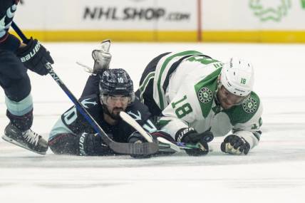 May 13, 2023; Seattle, Washington, USA; Seattle Kraken forward Matty Beniers (10) and Dallas Stars forward Max Domi (18) dive for a loose puck during the second period in game six of the second round of the 2023 Stanley Cup Playoffs at Climate Pledge Arena. Mandatory Credit: Stephen Brashear-USA TODAY Sports