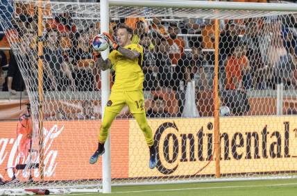 May 13, 2023; Houston, Texas, USA; Houston Dynamo goalkeeper Steve Clark (12) makes a save against the Seattle Sounders in the first half at Shell Energy Stadium. Mandatory Credit: Thomas Shea-USA TODAY Sports