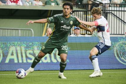 May 13, 2023; Portland, Oregon, USA;  Portland Timbers midfielder Evander (20) controls the ball during the first half against Vancouver Whitecaps midfielder Ryan Gauld (25)at Providence Park. Mandatory Credit: Troy Wayrynen-USA TODAY Sports