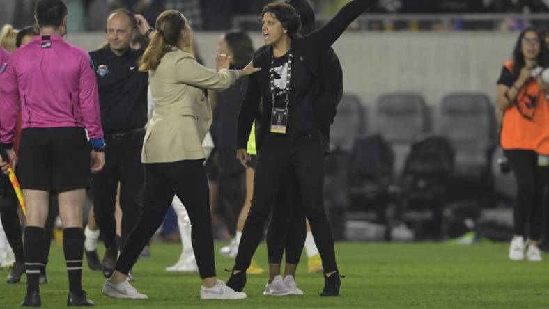 May 13, 2023; Los Angeles, California, USA;  Angel City FC president Julie Uhrman (right) is held back by Angel City FC head coach Freya Coombe during the second half at BMO Stadium. Mandatory Credit: Jayne Kamin-Oncea-USA TODAY Sports