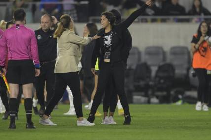 May 13, 2023; Los Angeles, California, USA;  Angel City FC president Julie Uhrman (right) is held back by Angel City FC head coach Freya Coombe during the second half at BMO Stadium. Mandatory Credit: Jayne Kamin-Oncea-USA TODAY Sports