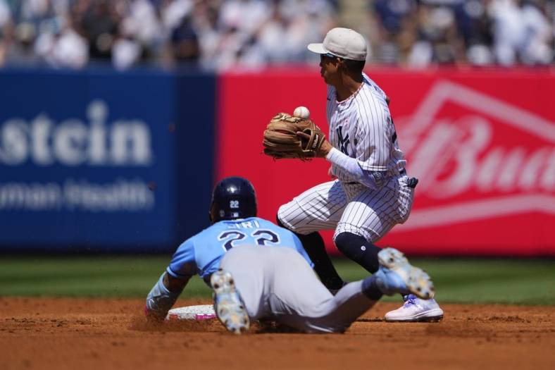 May 14, 2023; Bronx, New York, USA; Tampa Bay Rays center fielder Jose Siri (22) slides safely into second base with a double with New York Yankees second baseman Oswaldo Cabrera (95) receiving the throw during the third inning at Yankee Stadium. Mandatory Credit: Gregory Fisher-USA TODAY Sports