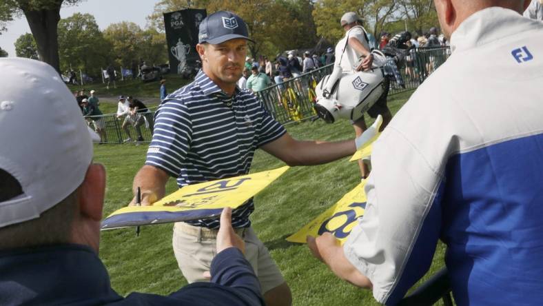 Bryson DeChambeau signs autographs for fans as he leaves the practice range before staring his practice round at the PGA Championship at Oak Hill Country Club Monday, May 15, 2023.