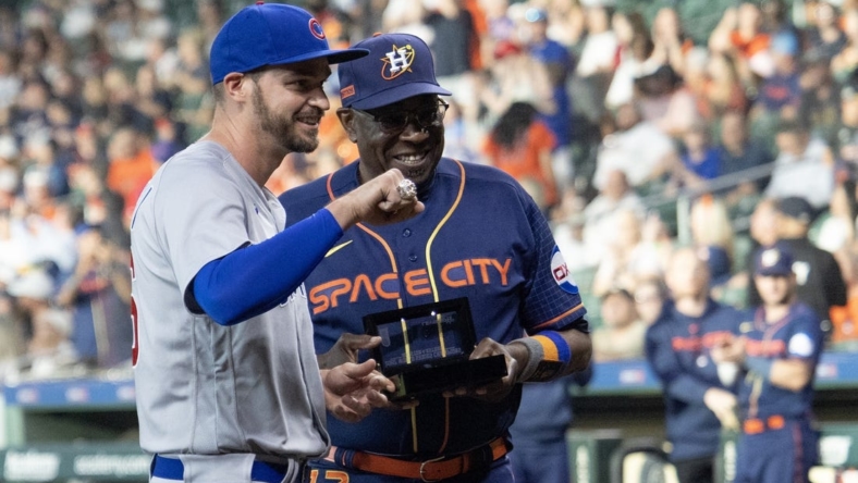 May 15, 2023; Houston, Texas, USA; Houston Astros manager Dusty Baker Jr. (12) hands Chicago Cubs first baseman Trey Mancini (36) his 2022 World Series ring before the game at Minute Maid Park. Mandatory Credit: Thomas Shea-USA TODAY Sports