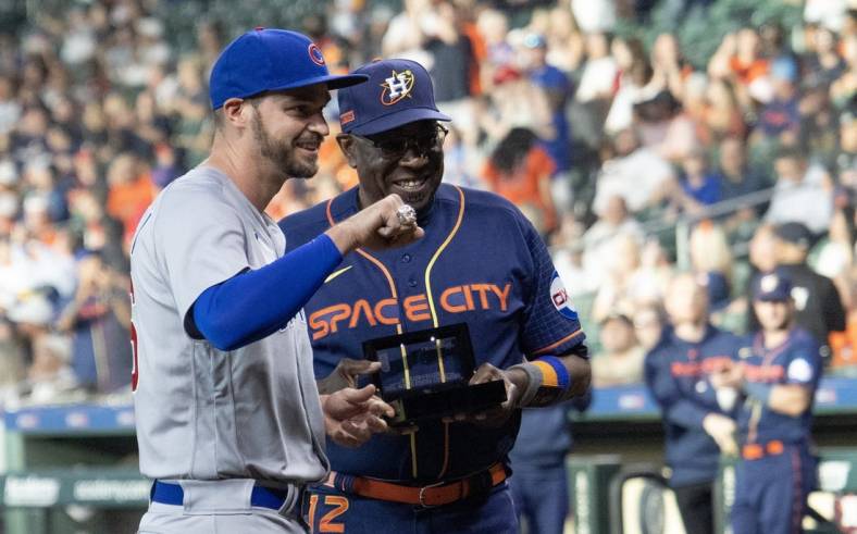 May 15, 2023; Houston, Texas, USA; Houston Astros manager Dusty Baker Jr. (12) hands Chicago Cubs first baseman Trey Mancini (36) his 2022 World Series ring before the game at Minute Maid Park. Mandatory Credit: Thomas Shea-USA TODAY Sports