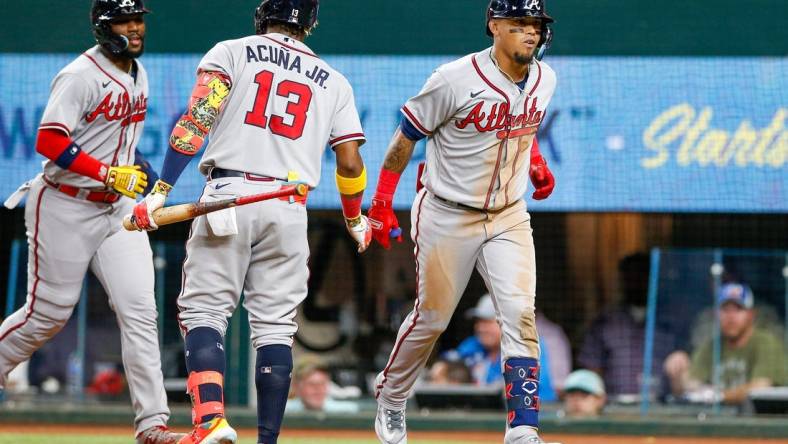 May 15, 2023; Arlington, Texas, USA; Atlanta Braves shortstop Orlando Arcia (11) is congratulated by right fielder Ronald Acuna Jr. (13) after he hits a two-run home run against the Texas Rangers during the sixth inning at Globe Life Field. Mandatory Credit: Andrew Dieb-USA TODAY Sports