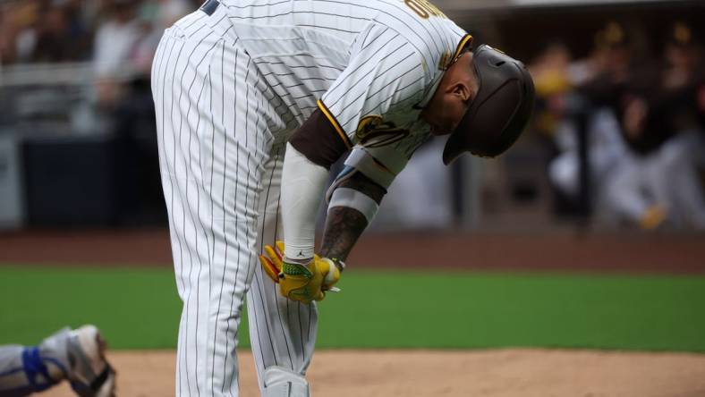 May 15, 2023; San Diego, California, USA;  San Diego Padres third baseman Manny Machado (13) reacts after being hit by a pitch during the second inning against the Kansas City Royals at Petco Park. Mandatory Credit: Kiyoshi Mio-USA TODAY Sports