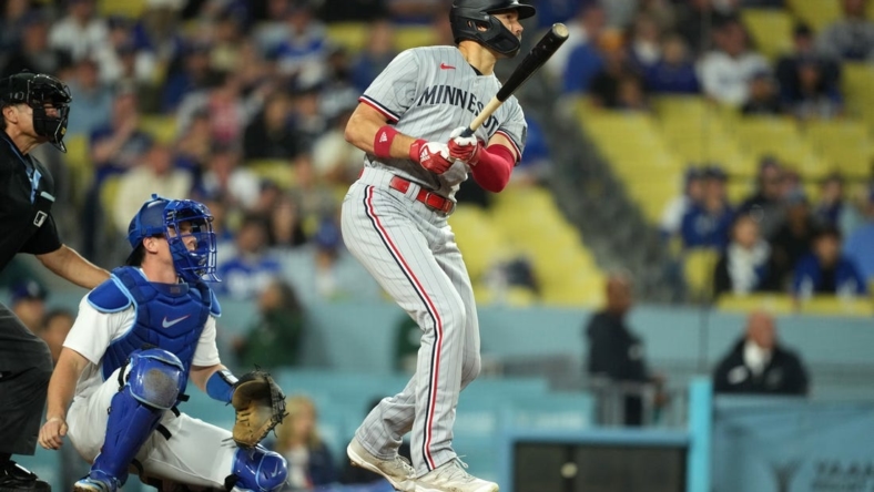 May 15, 2023; Los Angeles, California, USA; Minnesota Twins right fielder Trevor Larnach (9) follows through on a three-run home run in the eighth inning as Los Angeles Dodgers catcher Will Smith (16) reacts at Dodger Stadium. Mandatory Credit: Kirby Lee-USA TODAY Sports
