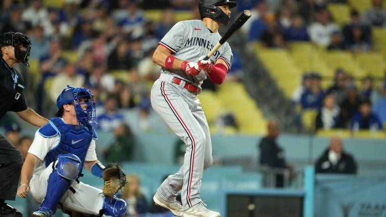 May 15, 2023; Los Angeles, California, USA; Minnesota Twins right fielder Trevor Larnach (9) follows through on a three-run home run in the eighth inning as Los Angeles Dodgers catcher Will Smith (16) reacts at Dodger Stadium. Mandatory Credit: Kirby Lee-USA TODAY Sports