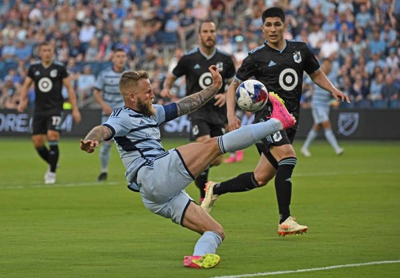 May 13, 2023; Kansas City, Kansas, USA;  Sporting Kansas City forward Johnny Russell (7) makes a play on the ball in the first half against Minnesota United at Children's Mercy Park. Mandatory Credit: Peter Aiken-USA TODAY Sports