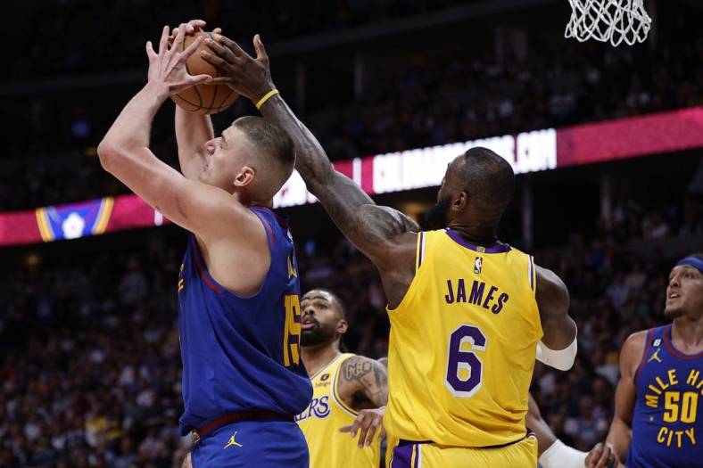 May 16, 2023; Denver, Colorado, USA; Los Angeles Lakers forward LeBron James (6) defends against Denver Nuggets center Nikola Jokic (15) in the second quarter during game one of the Western Conference Finals for the 2023 NBA playoffs at Ball Arena. Mandatory Credit: Isaiah J. Downing-USA TODAY Sports