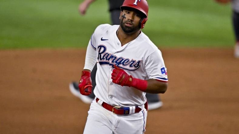 May 16, 2023; Arlington, Texas, USA; Texas Rangers shortstop Ezequiel Duran (20) rounds the bases after he hits a home run against the Atlanta Braves during the eighth inning at Globe Life Field. Mandatory Credit: Jerome Miron-USA TODAY Sports