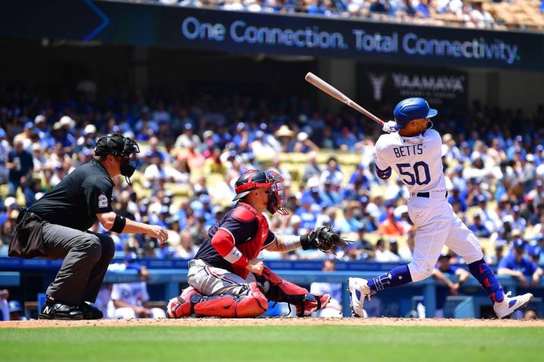 May 17, 2023; Los Angeles, California, USA; Los Angeles Dodgers right fielder Mookie Betts (50) hits an RBI single against the Minnesota Twins during the fourth inning at Dodger Stadium. Mandatory Credit: Gary A. Vasquez-USA TODAY Sports