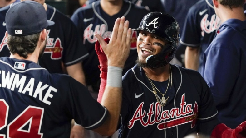 May 17, 2023; Arlington, Texas, USA; Atlanta Braves shortstop Orlando Arcia (11) is greeted in the dugout after hitting a go ahead solo home run against the Texas Rangers during the ninth inning at Globe Life Field. Mandatory Credit: Raymond Carlin III-USA TODAY Sports