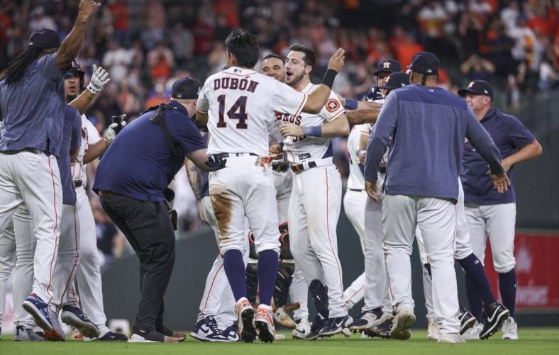 May 17, 2023; Houston, Texas, USA; Houston Astros designated hitter Kyle Tucker (30) celebrates with teammates after hitting a game-winning walk-off single during the ninth inning against the Chicago Cubs at Minute Maid Park. Mandatory Credit: Troy Taormina-USA TODAY Sports