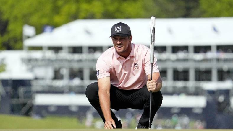 May 18, 2023; Rochester, New York, USA; Bryson DeChambeau lines up a putt on the ninth green during the first round of the PGA Championship golf tournament at Oak Hill Country Club. Mandatory Credit: Adam Cairns-USA TODAY Sports