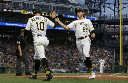 May 19, 2023; Pittsburgh, Pennsylvania, USA;  Pittsburgh Pirates left fielder Bryan Reynolds (10) and center fielder Jack Suwinski (65) high-five after both players scored runs against the Arizona Diamondbacks during the fourth inning at PNC Park. Mandatory Credit: Charles LeClaire-USA TODAY Sports
