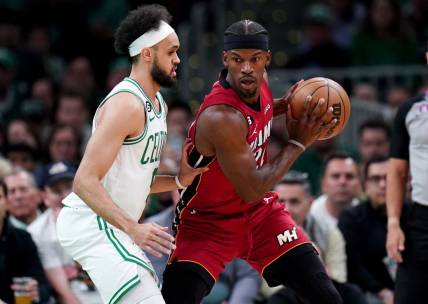 May 19, 2023; Boston, Massachusetts, USA; Miami Heat forward Jimmy Butler (22) looks to pass against Boston Celtics guard Derrick White (9) during the first half of game two of the Eastern Conference Finals for the 2023 NBA playoffs at TD Garden. Mandatory Credit: David Butler II-USA TODAY Sports