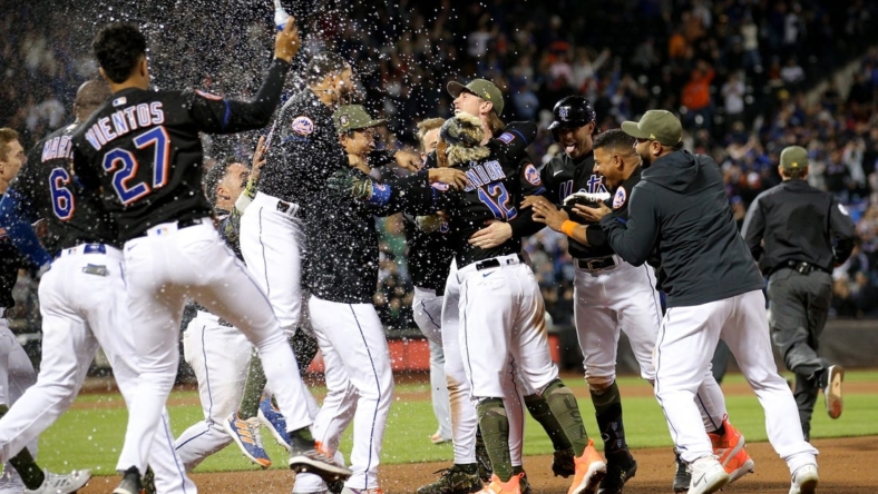 May 19, 2023; New York City, New York, USA; New York Mets shortstop Francisco Lindor (12) celebrates his walkoff RBI single against the Cleveland Guardians with teammates at Citi Field. Mandatory Credit: Brad Penner-USA TODAY Sports