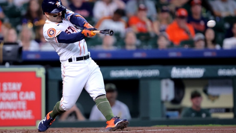 May 20, 2023; Houston, Texas, USA; Houston Astros second baseman Jose Altuve (27) hits a double against the Oakland Athletics during the first inning at Minute Maid Park. Mandatory Credit: Erik Williams-USA TODAY Sports