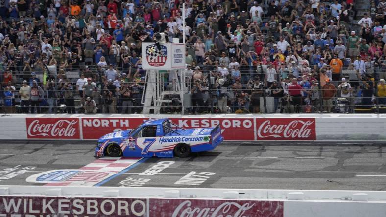 May 20, 2023; North Wilkesboro, North Carolina, USA;  NASCAR Craftsman Truck Series driver Kyle Larson (7) crosses the finish line during the Tyson 250 at North Wilkesboro Speedway. Mandatory Credit: Jim Dedmon-USA TODAY Sports