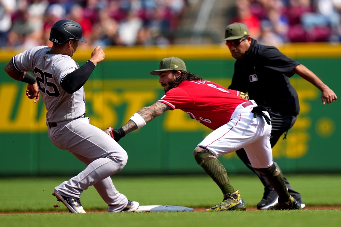 New York Yankees second baseman Gleyber Torres (25) reaches back to second base before Cincinnati Reds second baseman Jonathan India (6) can apply the tag in the first inning during a baseball game between the New York Yankees and the Cincinnati Reds, Saturday, May 20, 2023, at Great American Ball Park in Cincinnati.