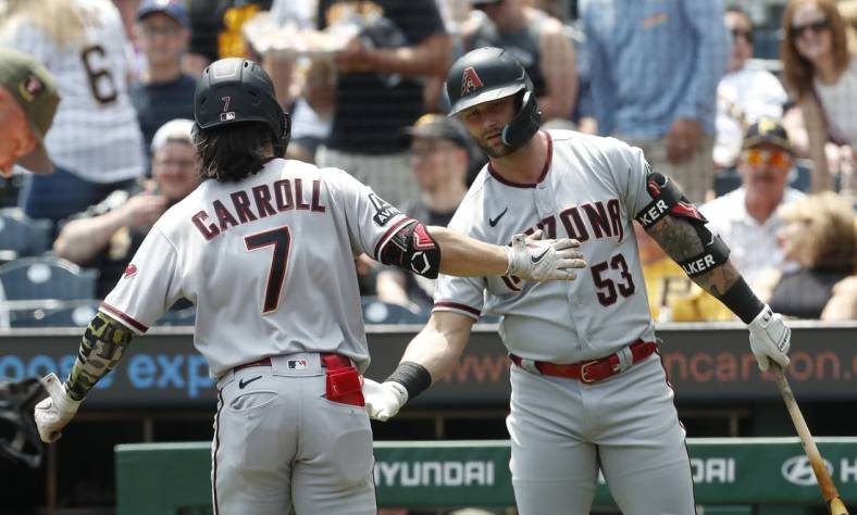 May 21, 2023; Pittsburgh, Pennsylvania, USA;  Arizona Diamondbacks first baseman Christian Walker (53) congratulates right fielder Corbin Carroll (7) crossing home plate on a solo home run against the Pittsburgh Pirates during the first inning at PNC Park. Mandatory Credit: Charles LeClaire-USA TODAY Sports