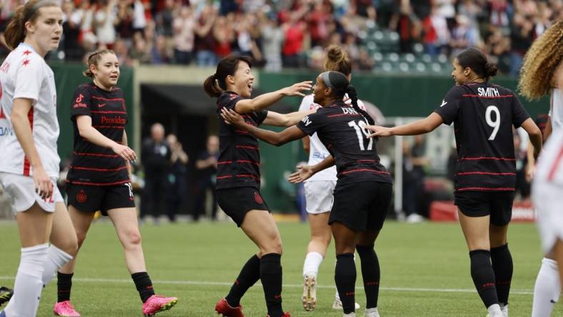 May 21, 2023; Portland, Oregon, USA; Portland Thorns FC midfielder Crystal Dunn (19) celebrates a goal with midfielder Hina Sugita (8) in the first half against the Chicago Red Stars at Providence Park. Mandatory Credit: Soobum Im-USA TODAY Sports