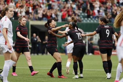 May 21, 2023; Portland, Oregon, USA; Portland Thorns FC midfielder Crystal Dunn (19) celebrates a goal with midfielder Hina Sugita (8) in the first half against the Chicago Red Stars at Providence Park. Mandatory Credit: Soobum Im-USA TODAY Sports