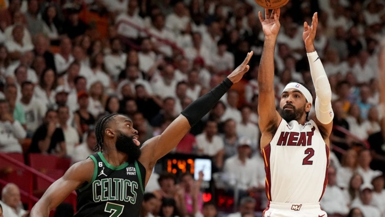 May 21, 2023; Miami, Florida, USA; Miami Heat guard Gabe Vincent (2) shoots against Boston Celtics guard Jaylen Brown (7) during the first half in game three of the Eastern Conference Finals for the 2023 NBA playoffs at Kaseya Center. Mandatory Credit: Jim Rassol-USA TODAY Sports